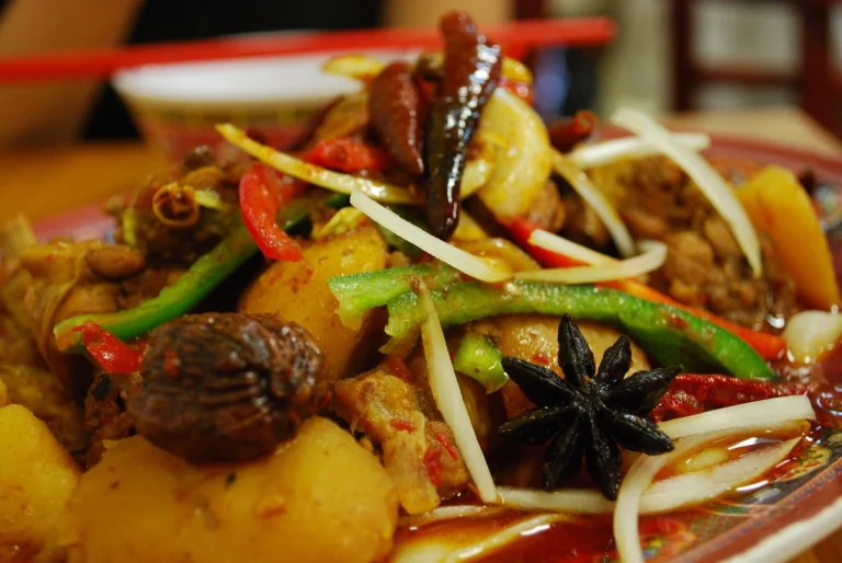 A delicious plate of spicy vegetables garnished with fresh herbs and served in a rustic bowl.