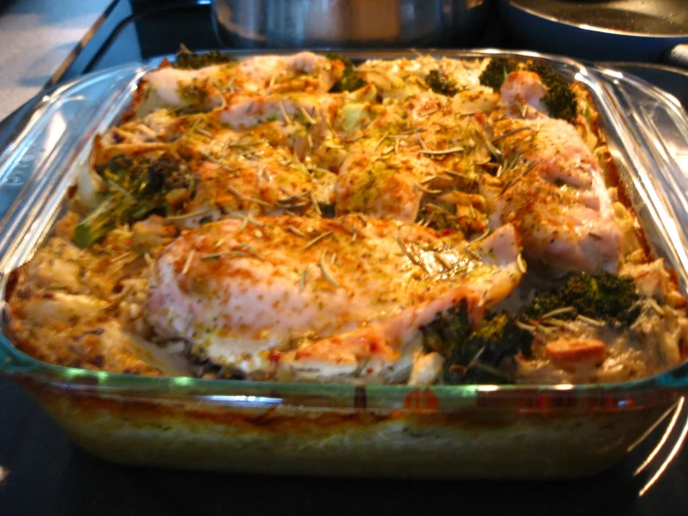 A warm and hearty Chicken Broccoli Rice Casserole, topped with melted cheese, served in a baking dish with a golden crust.