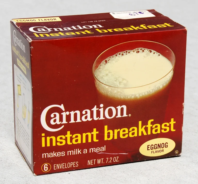 A box of Carnation Instant Breakfast powder packets in assorted flavors, used for quick and nutritious breakfast options.