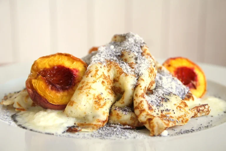 Peach breakfast recipes featuring fluffy pancakes with fresh peach slices and syrup."