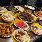 Delicious Filipino dishes including Kare-Kare, Sinigang, and Pancit, showcasing a vibrant spread of traditional Filipino flavors.