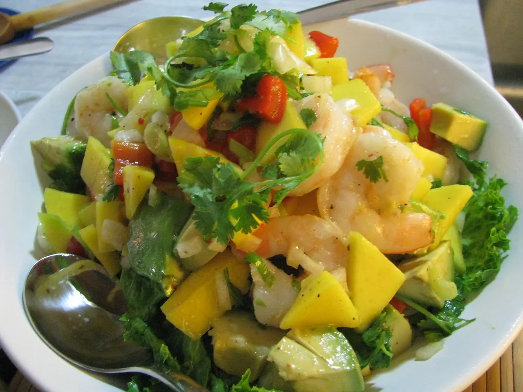 Fresh mango avocado salad with diced mango, creamy avocado, red onion, cilantro, and a light citrus dressing, served in a white bowl