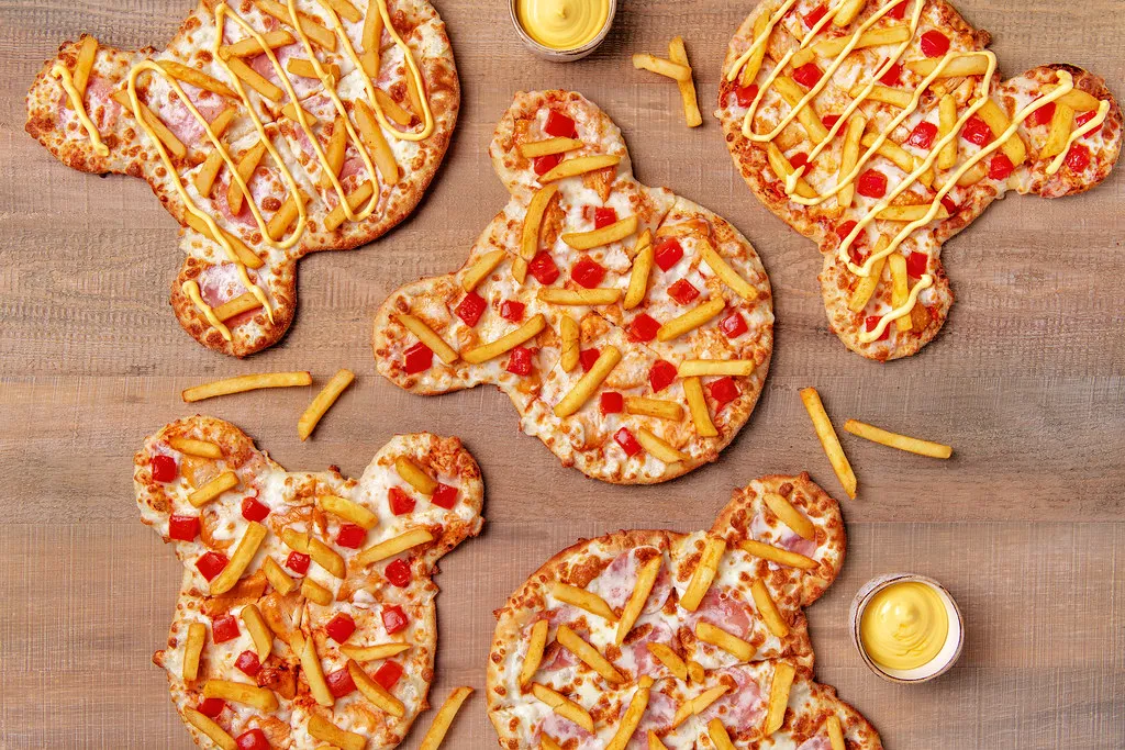  A fun, kid-friendly homemade pizza with a crispy crust, gooey cheese, and playful toppings arranged in a smiley face.