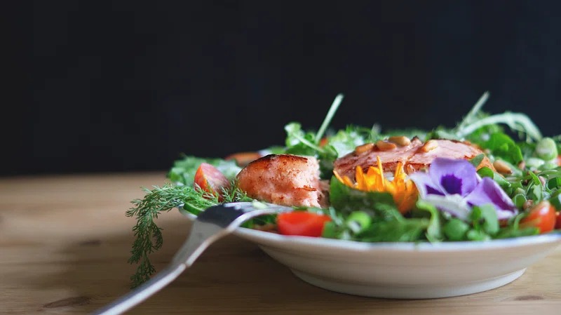 A hearty kale crunch salad topped with grilled chicken and a light vinaigrette dressing