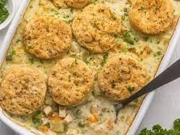 An image showing the casserole after it's baked, topped with fresh herbs