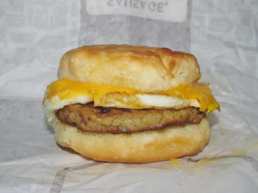 A homemade Sausage, Egg & Cheese Biscuit featuring a golden, flaky biscuit, a savory sausage patty, a fluffy folded egg, and melted cheese, inspired by Burger King’s breakfast menu.