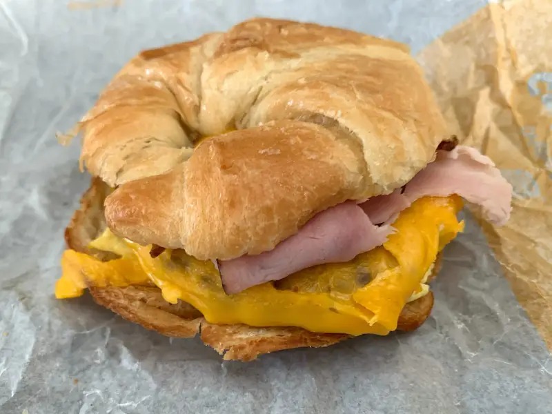 A freshly made homemade Croissan’wich with a buttery, flaky croissant, fluffy folded egg, melted cheese, and a savory sausage patty, inspired by Burger King’s classic breakfast sandwich.