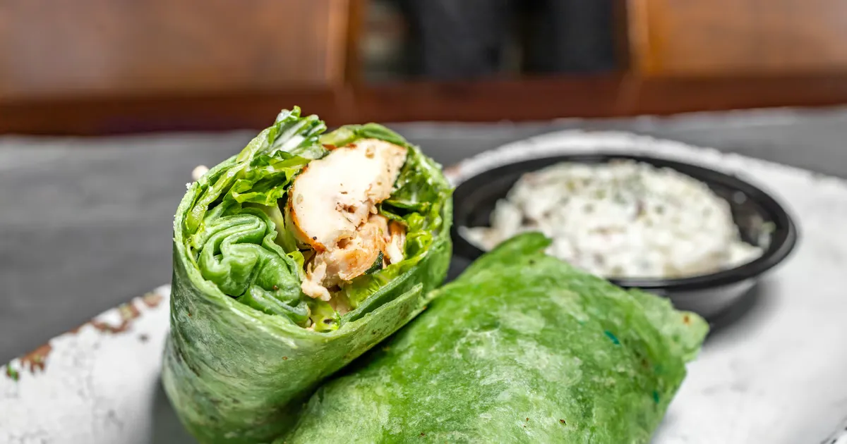 Delicious Chicken Caesar Wrap filled with grilled chicken, crisp romaine lettuce, creamy Caesar dressing, and Parmesan cheese, wrapped in a soft tortilla