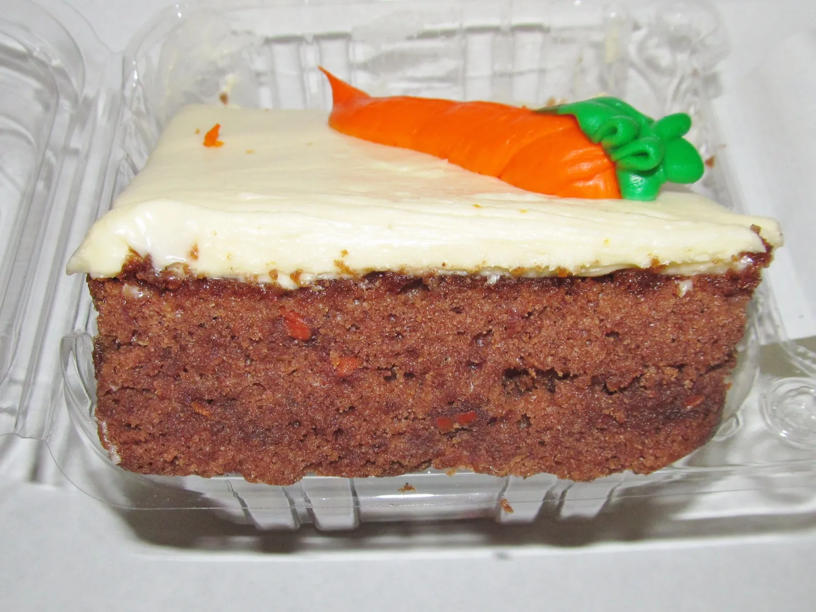 A moist slice of carrot cake with rich cream cheese frosting