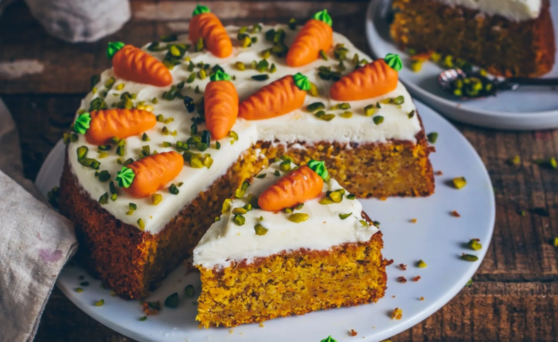 A boxed carrot cake mix placed on a wooden kitchen counter, ready for baking.