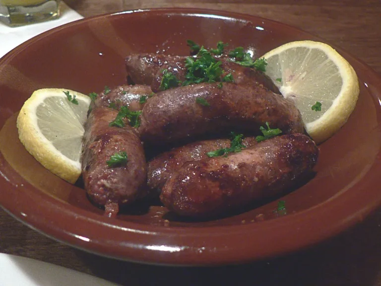 Grilled beef Italian sausage served with sautéed peppers and onions on a rustic plate.