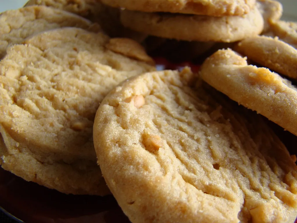 Freshly baked peanut butter cookies made in an air fryer, golden brown and crispy on the edges.