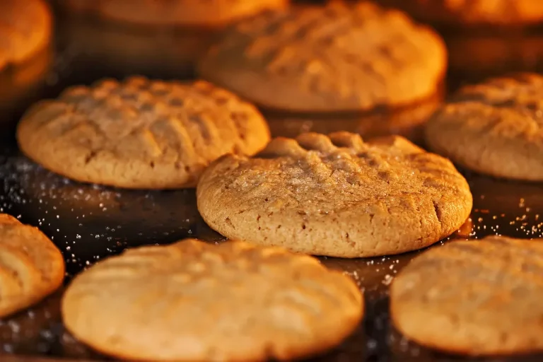 “Golden-brown peanut butter cookies made in an air fryer, stacked on a plate with a crispy edge and soft center