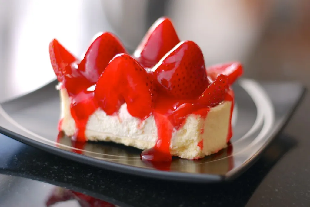 Strawberry Cheesecake Crunch Cake with a golden Oreo crust and fresh strawberry topping