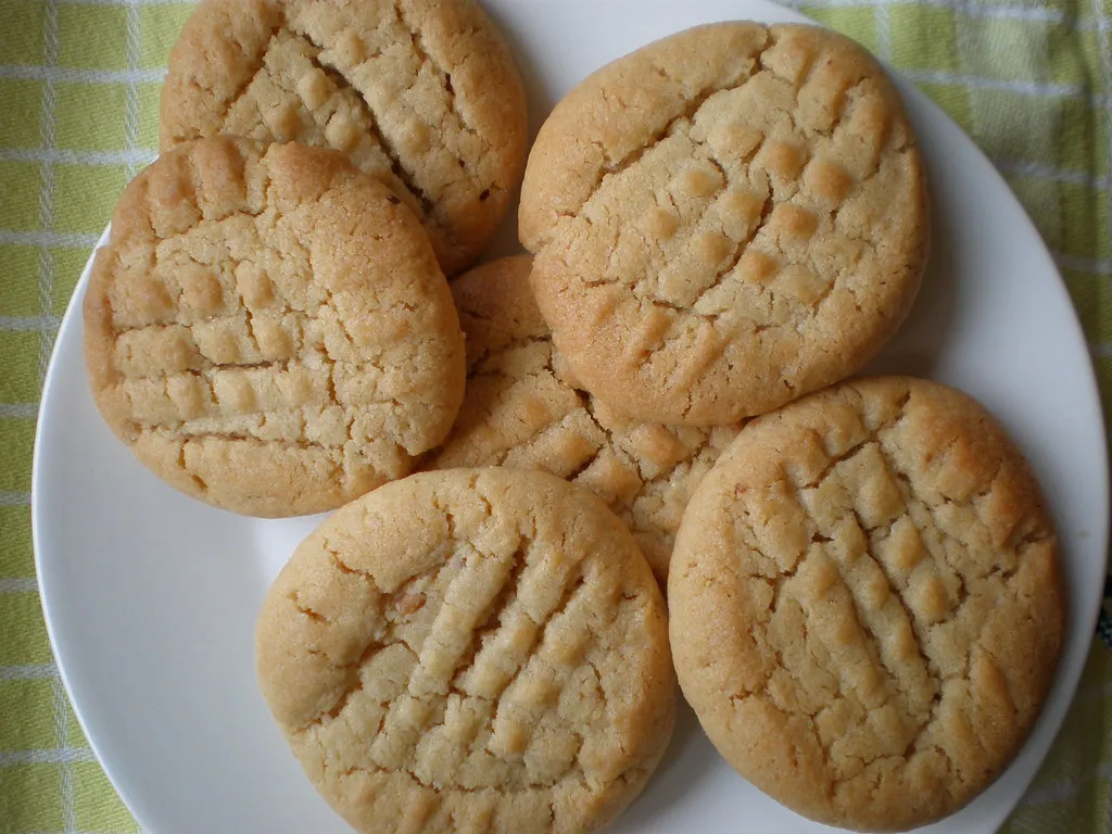 Close-up of soft and chewy air fryer peanut butter cookies with a criss-cross fork pattern
