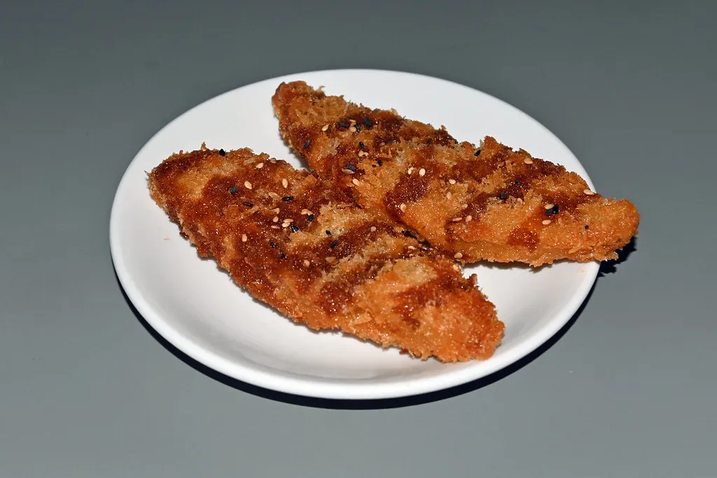 Baked fish fillets seasoned with herbs and lemon, ready to serve for a delicious meal.