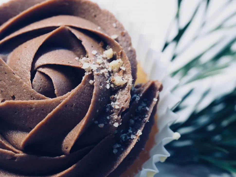 Decadent chocolate cake topped with smooth ganache or creamy buttercream, creating a rich and indulgent dessert perfect for any occasion.