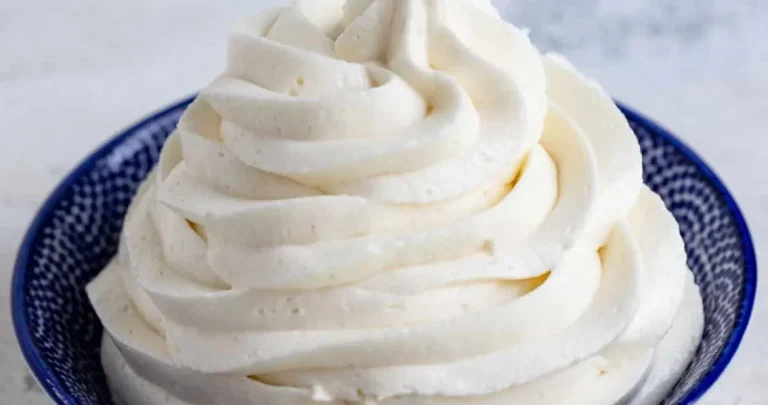 A beautifully decorated lemon cake with zesty lemon frosting and fresh lemon slices on top