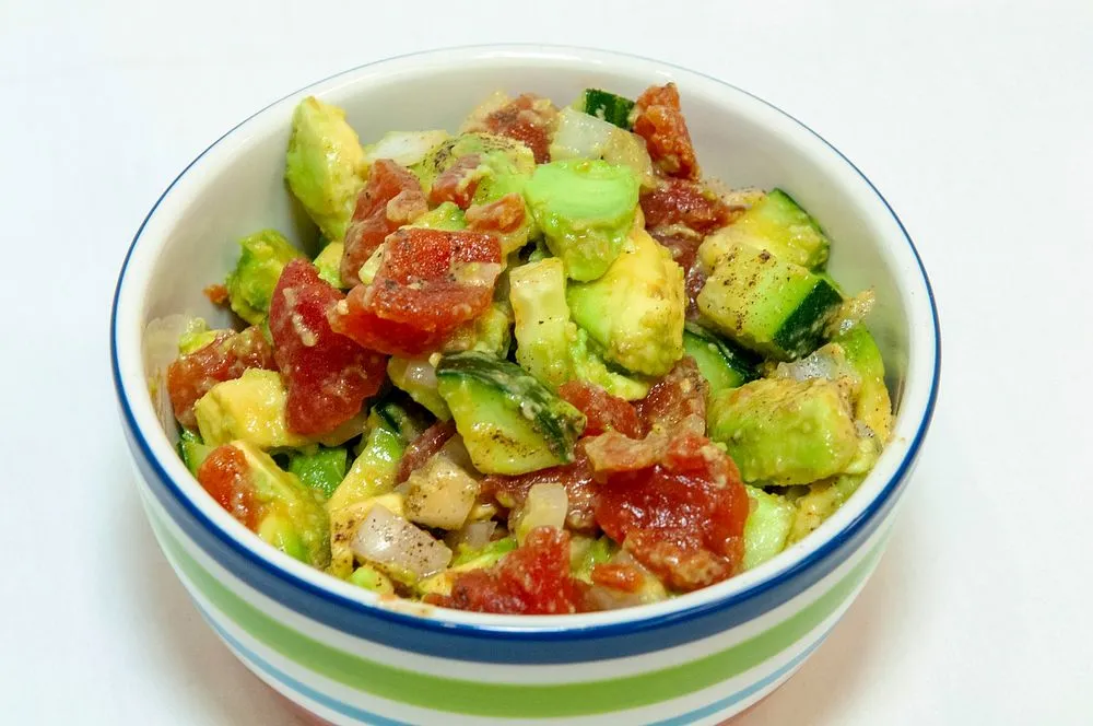 Fresh and vibrant avocado salad with mixed greens, cherry tomatoes, and a light dressing, perfect for a healthy and delicious meal.