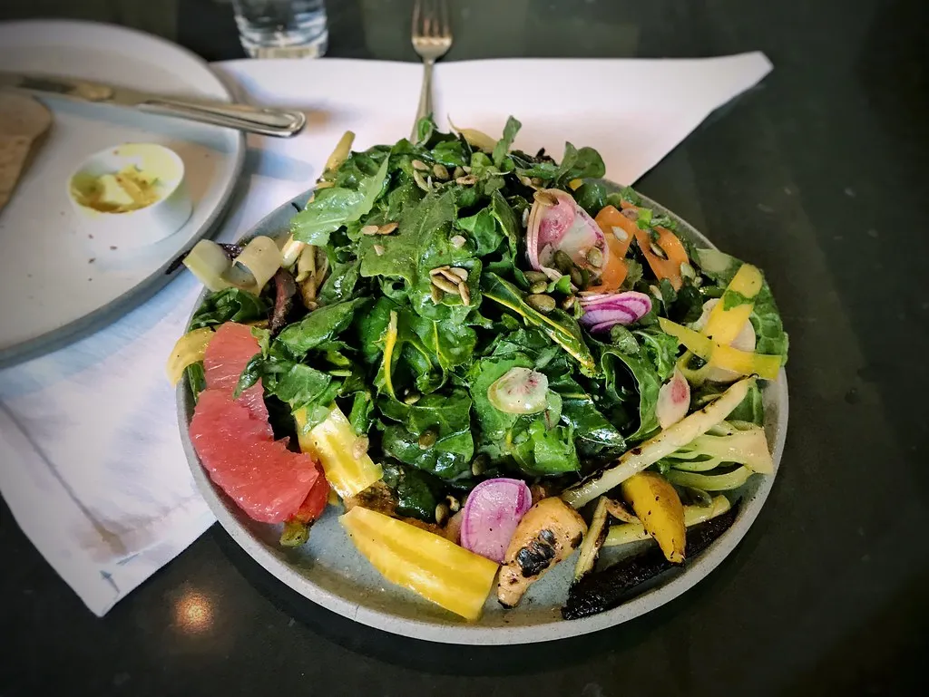 Homemade healthy salad with kale, lemon dressing, and sunflower seeds