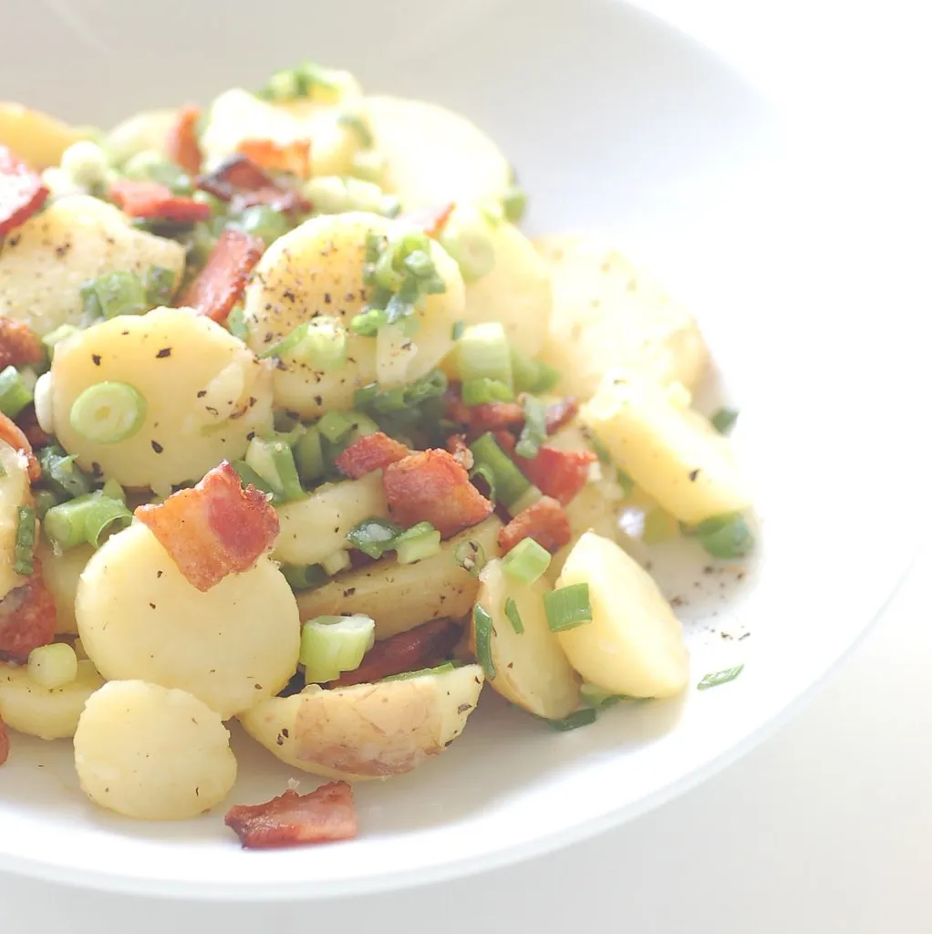 Cozy kitchen scene with a Ninja NeverStick saucepan gently boiling potatoes—perfect for making comforting warm potato salad