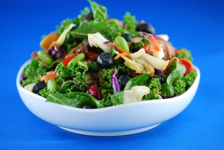 Fresh and vibrant healthy salad with mixed greens, colorful vegetables, nuts, and a light dressing.