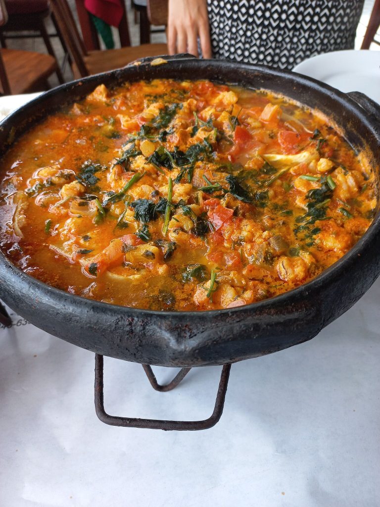 Fresh Mounjaro-friendly ingredients like bell peppers, garlic, coconut milk, herbs, and shrimp arranged on a wooden cutting board