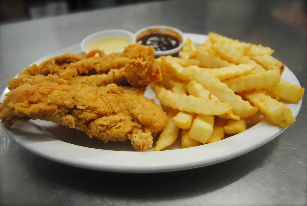 Crispy golden chicken tenders served with a side of dipping sauces