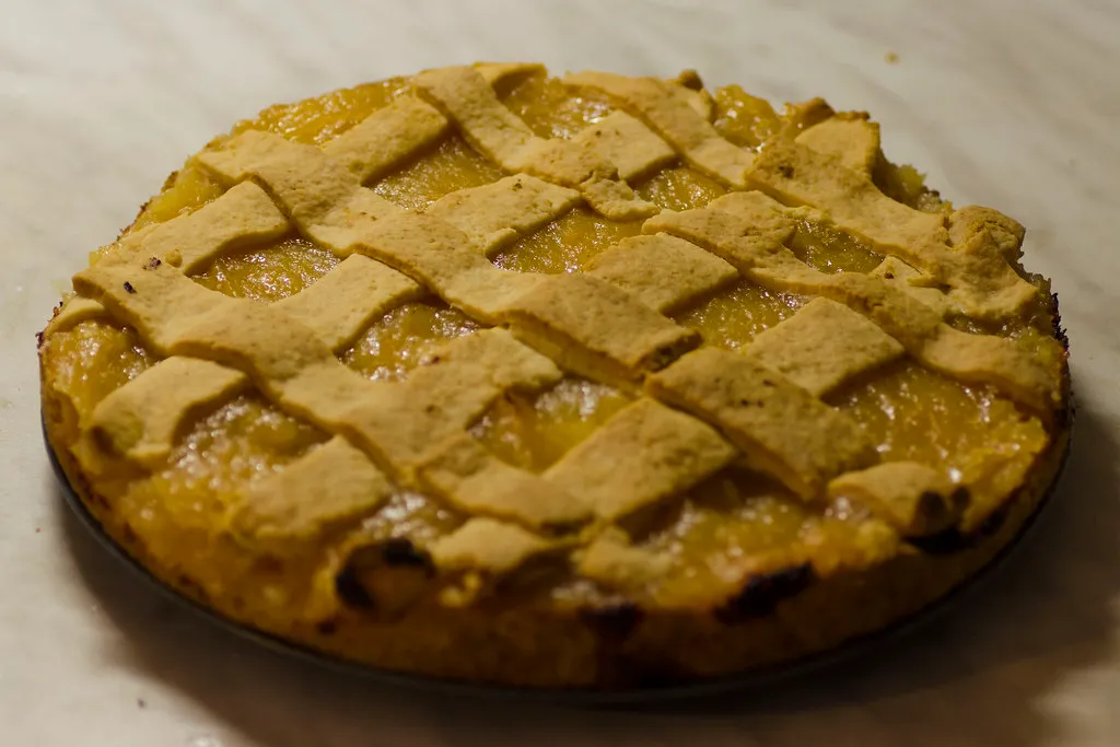 Close-up of a moist quince cake with slices of poached quince arranged on top