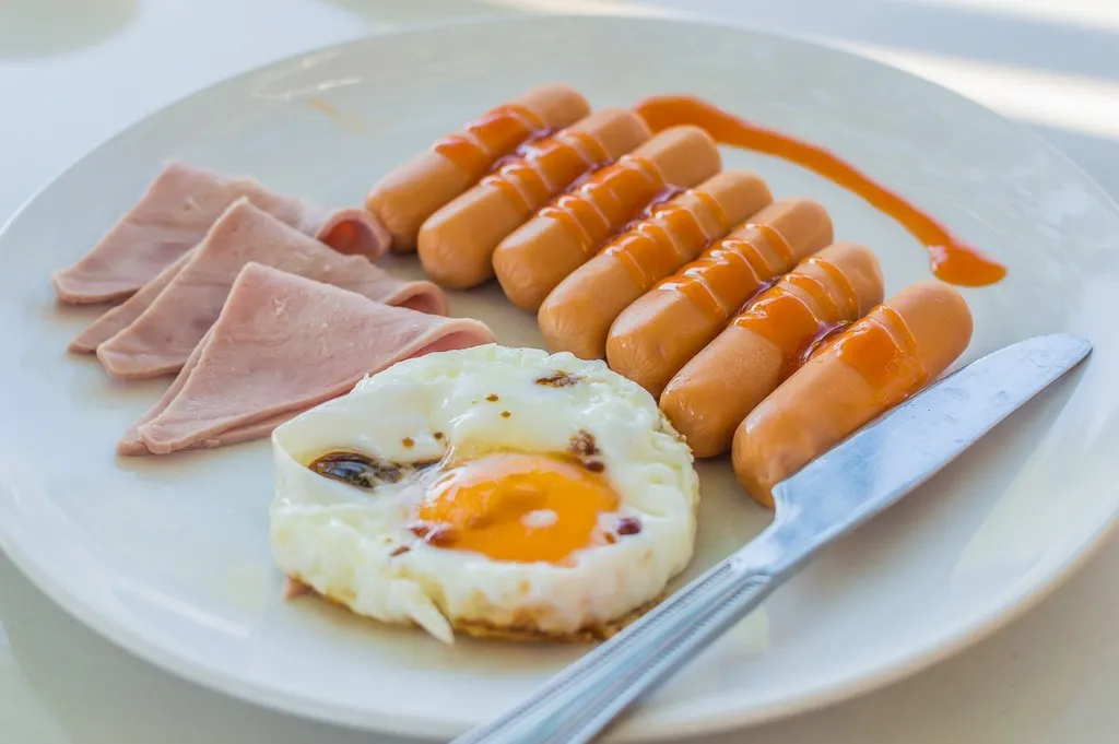 Crispy hash browns served with sizzling breakfast meats on a plate