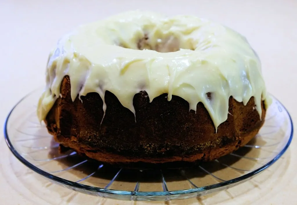 A beautifully frosted pound cake with various icing options, perfect for elevating your homemade desserts