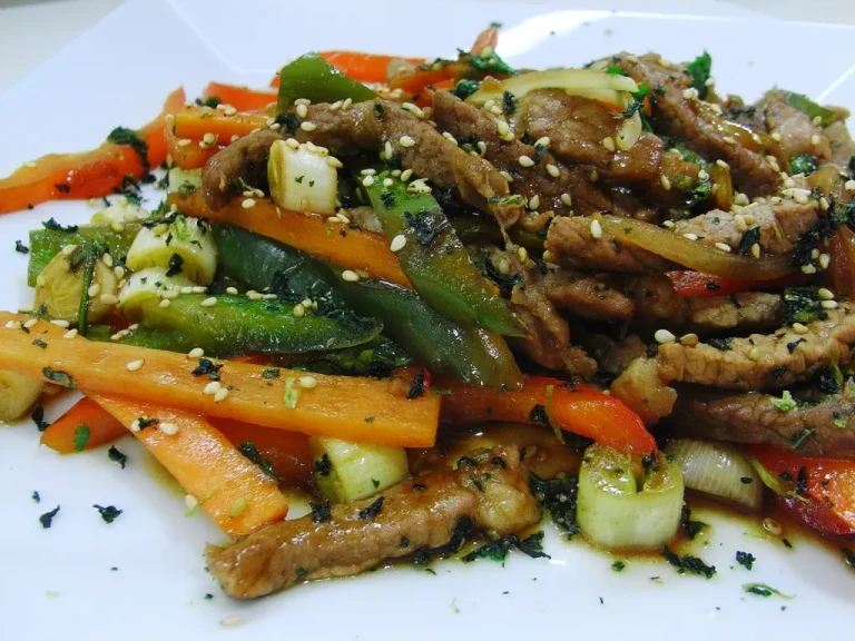 Oriental salad with shredded cabbage, carrots, mandarin oranges, and crunchy ramen noodles topped with sesame ginger dressing
