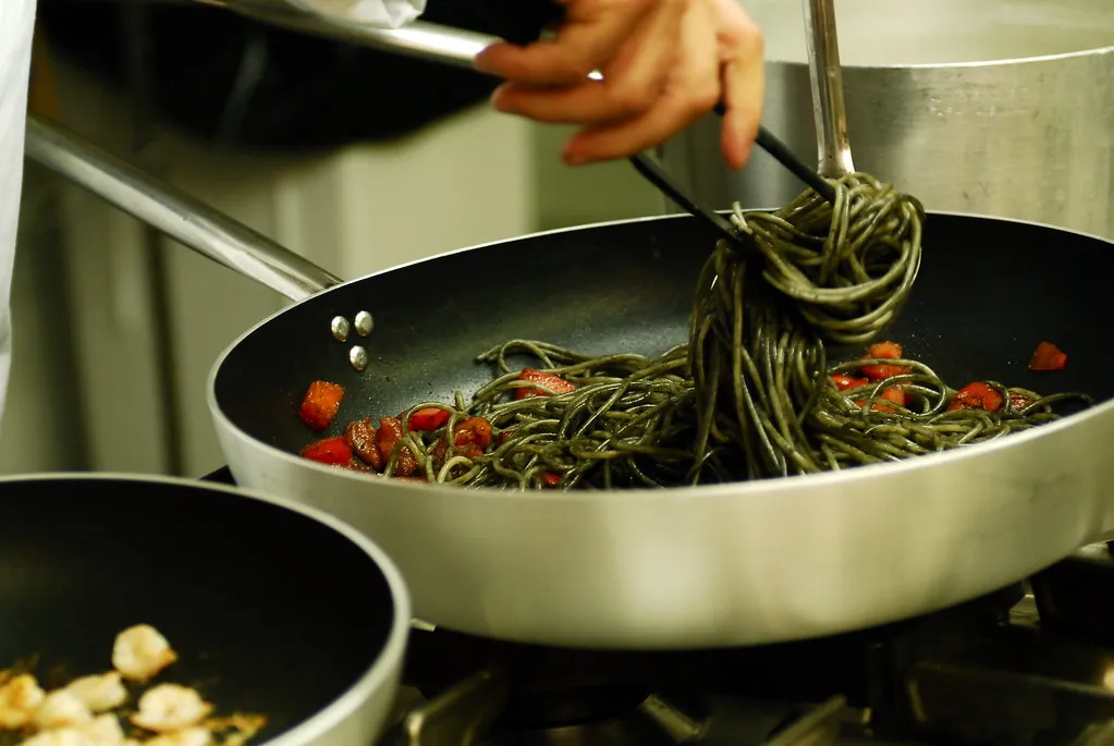Elegant black spaghetti dish with seared scallops and chili flakes