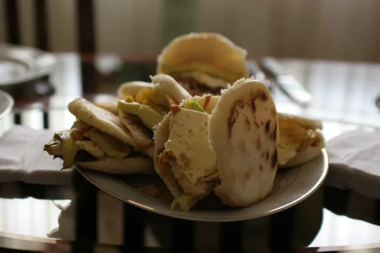 Authentic Colombian arepas con queso served hot with melted cheese on a rustic plate