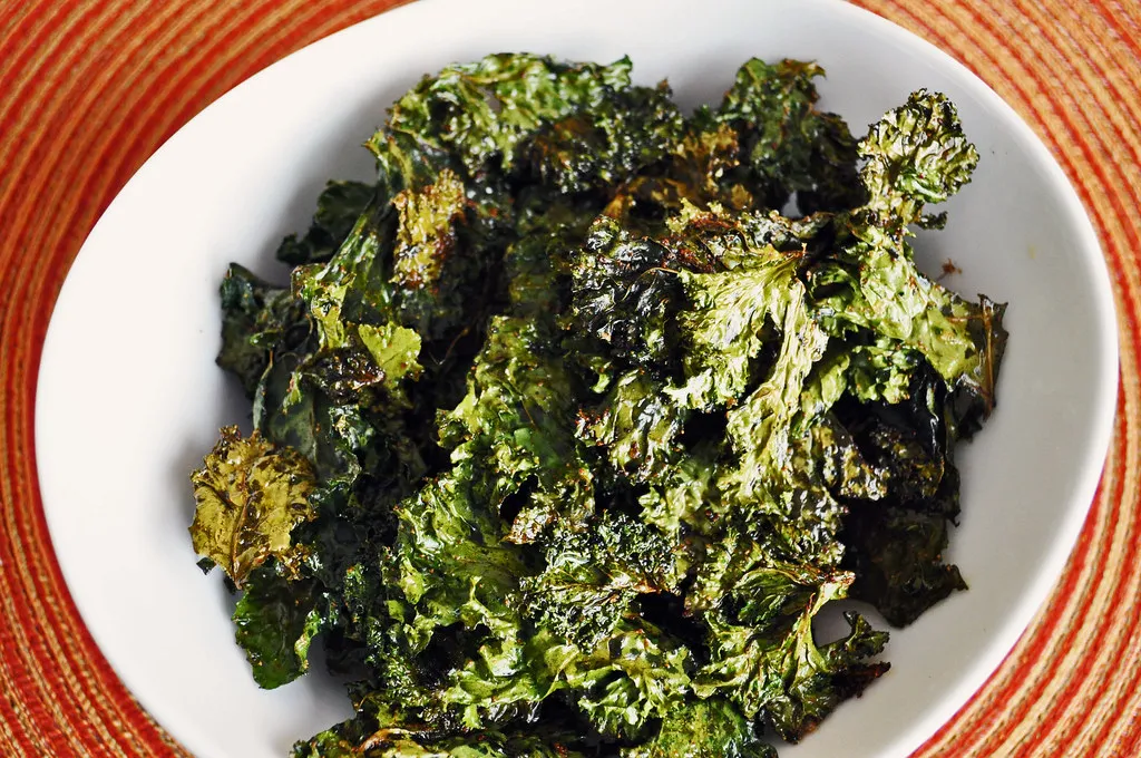 Crispy air fried kale chips in a bowl, seasoned and ready to eat