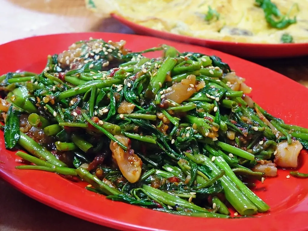 Healthy Oriental salad served in a meal prep container with separate sesame ginger dressing