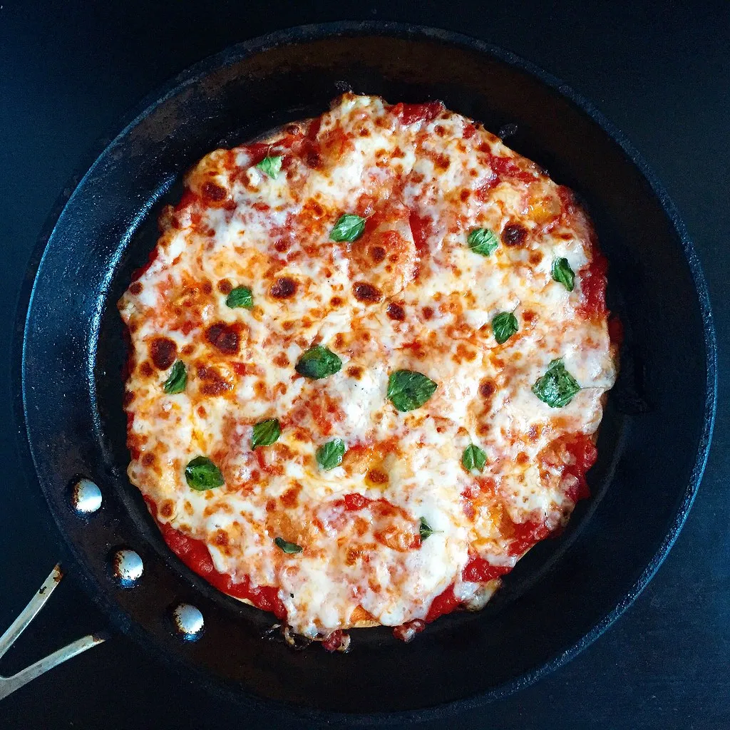 Crispy tortilla pizza topped with melted mozzarella, pepperoni, and basil