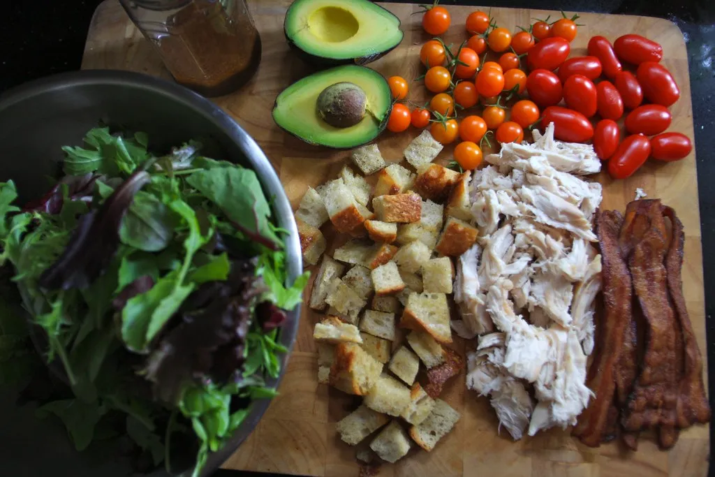BLT salad with bacon, lettuce, tomatoes, avocado, croutons, dressing