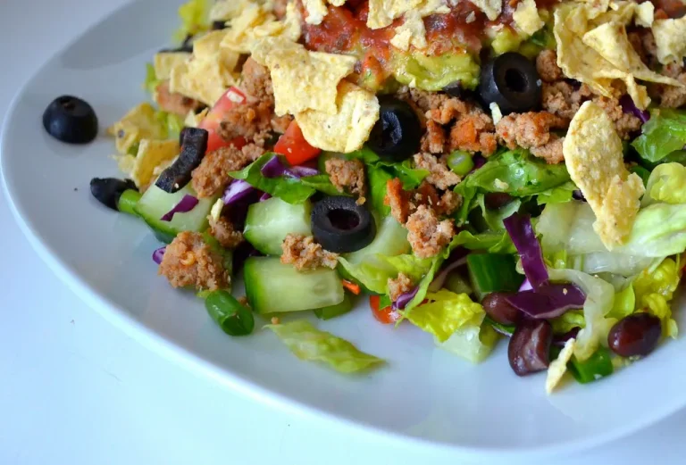 Creamy homemade turkey salad with celery, cranberries, and herbs served in a white bowl