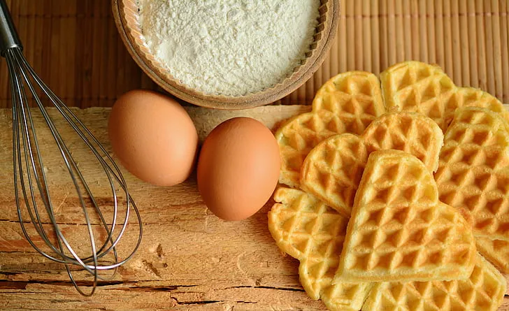 Ingredients for Eggo French toast including frozen waffles, eggs, milk, cinnamon, vanilla, and butter