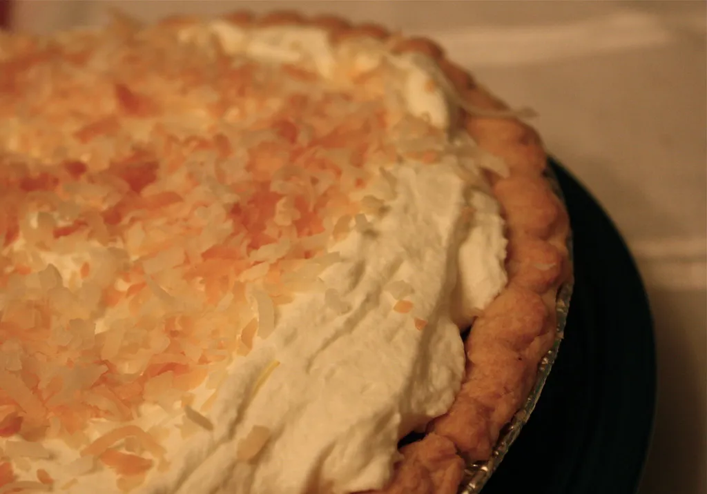 Quick and creamy coconut cream pie with whipped cream and toasted coconut on top