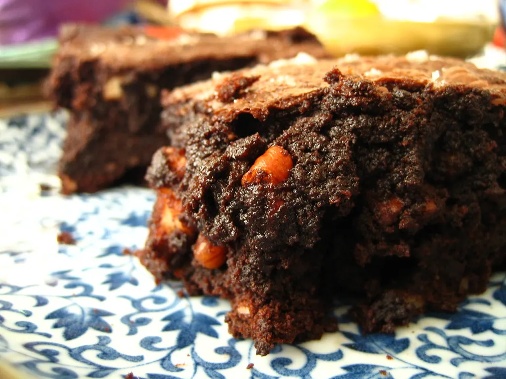 Decadent gooey brownies with a fudgy center and crackly top served on a white plate