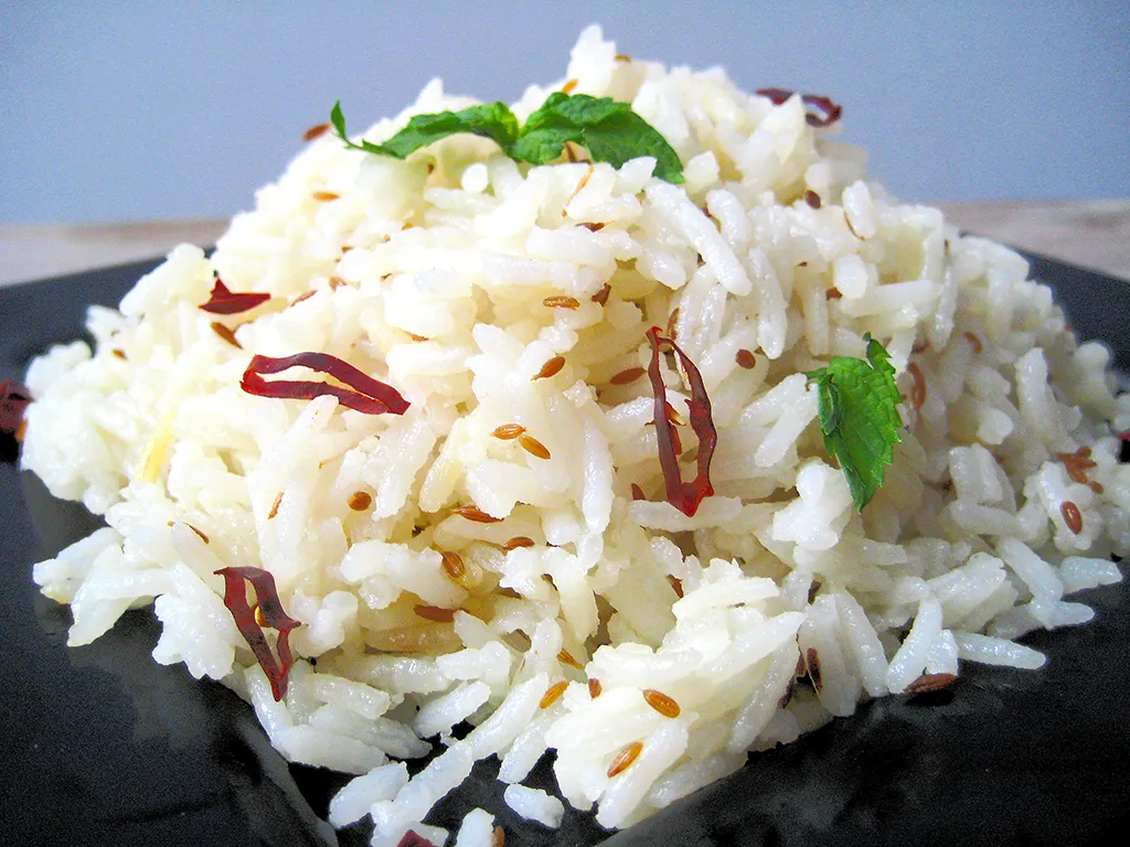 Traditional Indian biryani served in a clay pot with vegetables and herbs