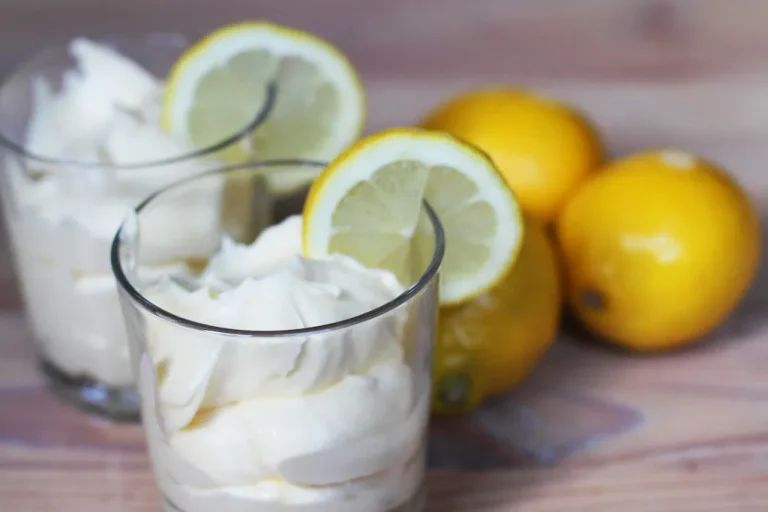 Light and creamy lemon mousse served in glass cups topped with fresh berries and lemon zest