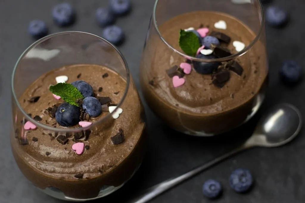  Glass cup filled with rich chocolate mousse topped with whipped cream and dark chocolate shavings