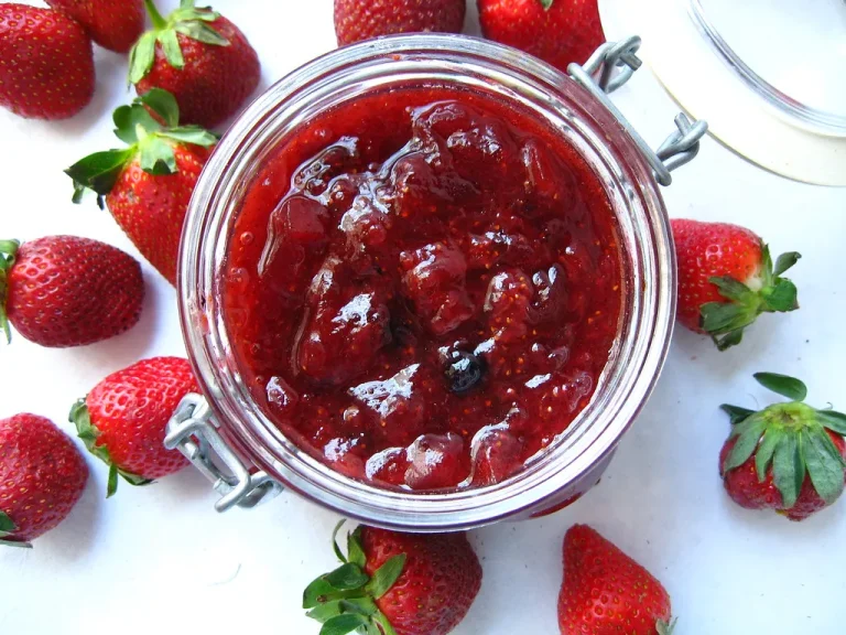 Strawberry compote served over fluffy pancakes with syrupy chunks of fruit