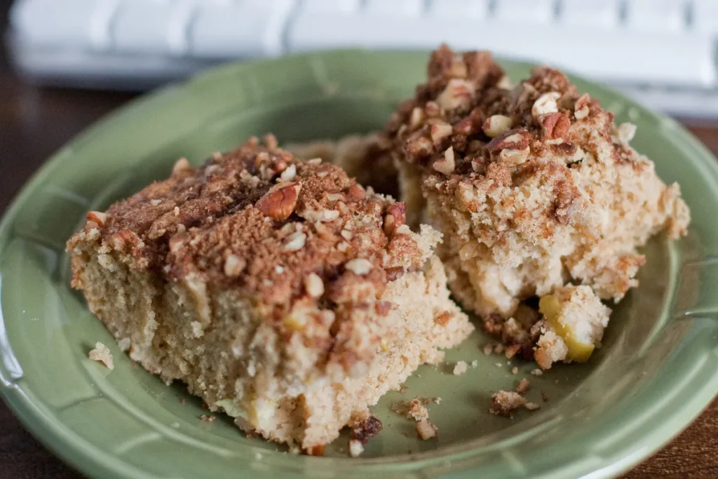 Homemade apple sauce coffee cake with cinnamon streusel topping served on a plate