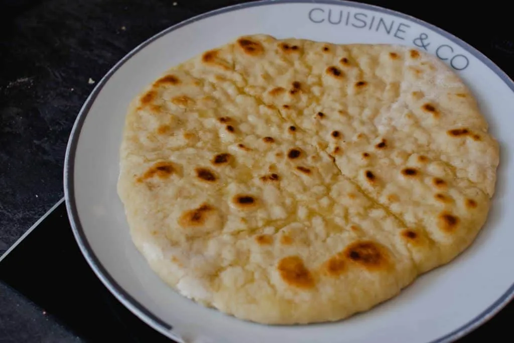 Freshly baked Arabic pita bread served warm on a wooden board