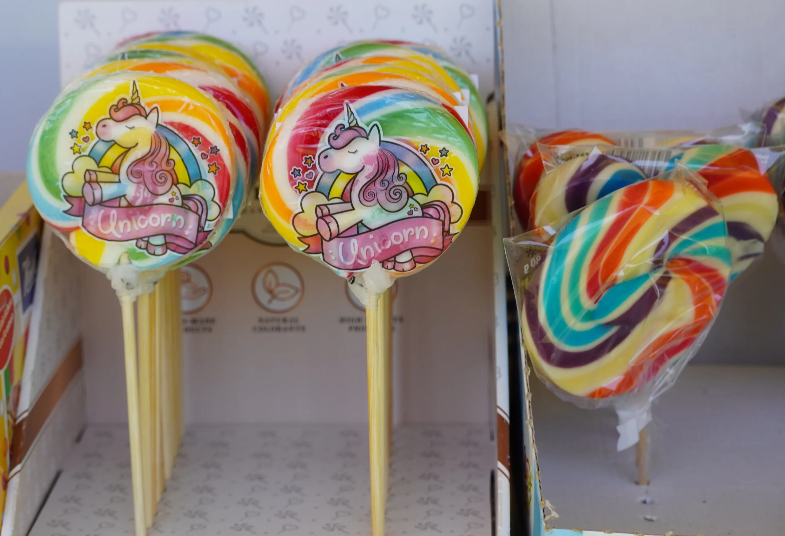 Colorful homemade lollipops on sticks arranged on a white background