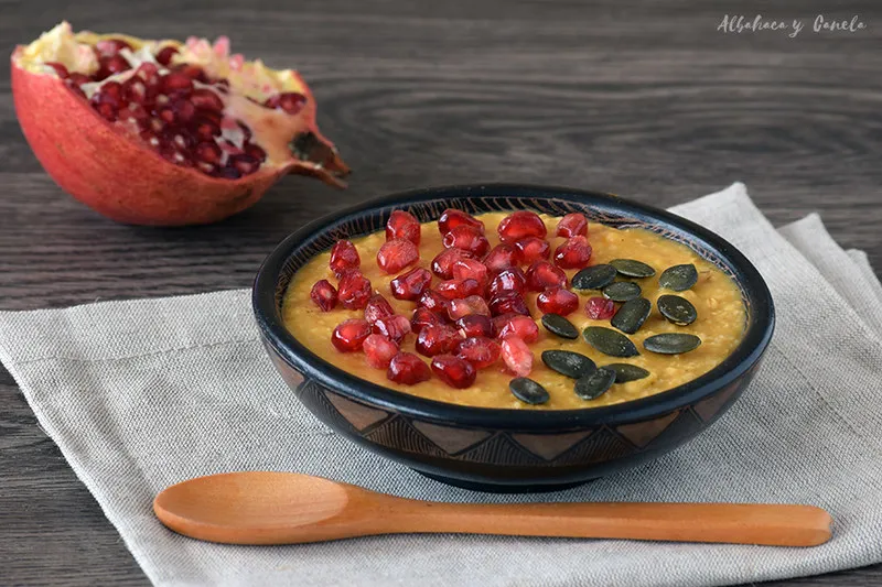 Warm pumpkin oatmeal served in a bowl with cinnamon and chopped nuts